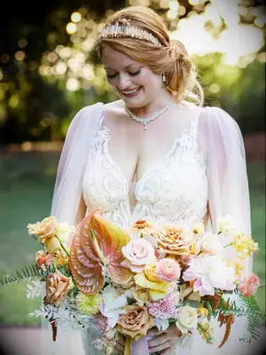 Bride holding orange bouquet
