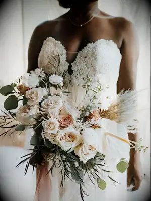 Bride holding bouquet of roses