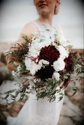 elegant fall wedding bouquet with dark red dahlias and white roses