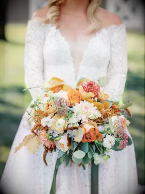elegant orange and peach fall wedding bouquet with eucalyptus