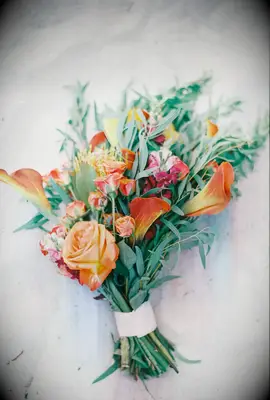 unique fall wedding bouquet with orange roses, calla lilies and greenery