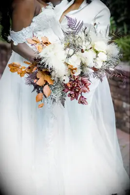 unique fall wedding bouquets with ferns, orange leaves, red orchids and pampas grass
