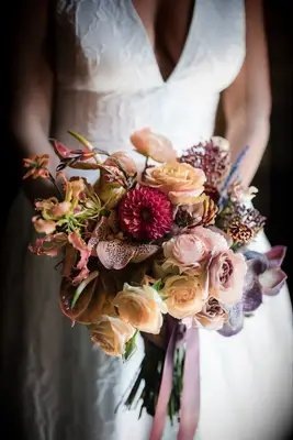 Bride holding bouquet with lilies