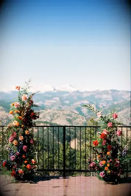 Floral arrangements frame this breathtaking mountain view.
