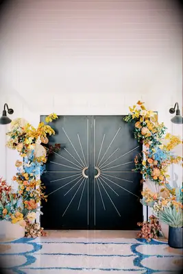Autumnal floral arrangements frame this stunning art deco doorway.