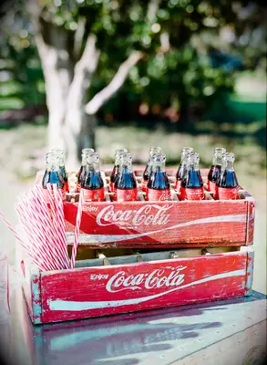 vintage crates with glass coca cola bottles and red striped straws