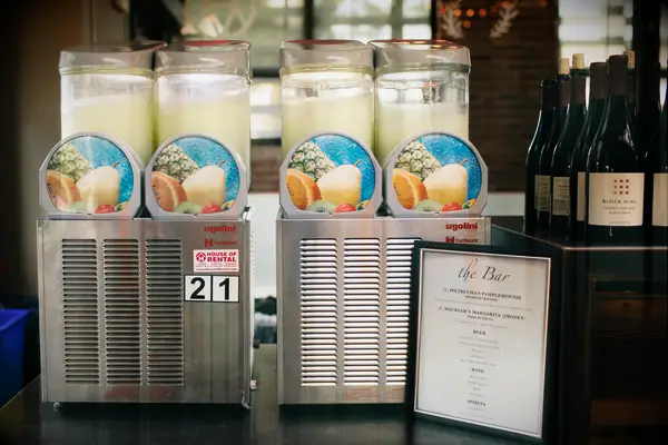 frozen margarita machines at wedding drink station