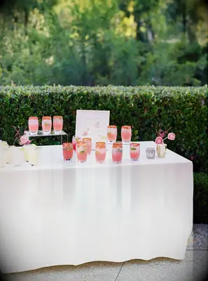 table with pink margaritas and custom wedding drink sign