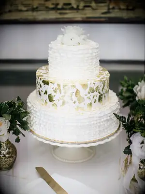 buttercream wedding cake with gold leaf foil