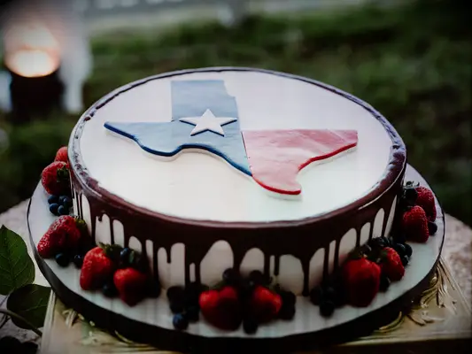 groom cake with texas flag and chocolate drip icing 