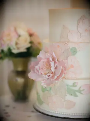 close-up of wedding cake with pink gum paste sugar flower 