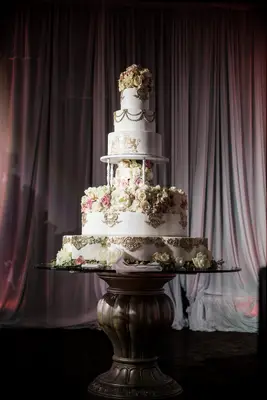 oversized five tier wedding cake with pillars and blush roses