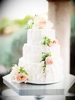 three-tier buttercream wedding cake with blush roses