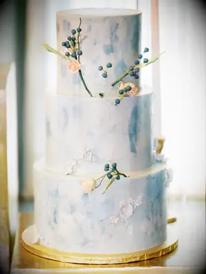 three tier blue fondant wedding cake with gold foil cake board