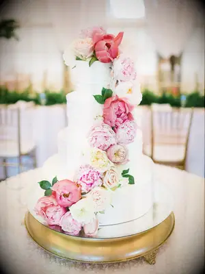 white buttercream wedding cake with cascading garden rose and peony decoration
