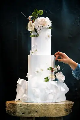 three tier luxury wedding cake with sculpted sugar flowers
