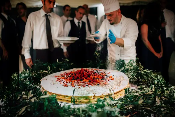 Amazing traditional millefoglie assembled in front of wedding guests. 