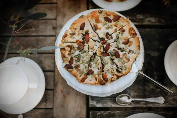 Rustic almond tart topped with mixed nuts. 