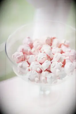 Pig-shaped pink candies in a glass bowl. 