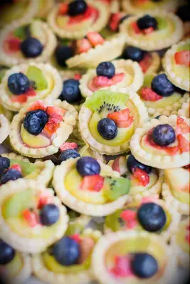 Mini tarts topped with fresh fruit. 