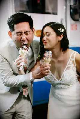 Couple enjoys soft serve ice cream at their wedding. 