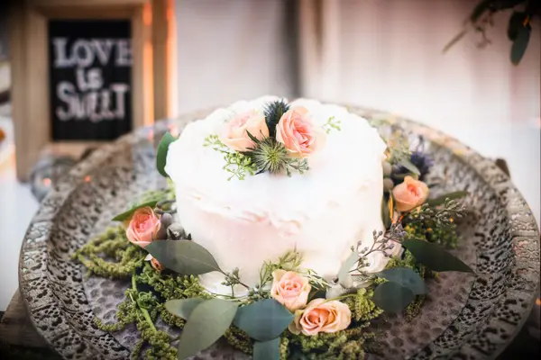 Beautifully decorated ice cream cake adorned with fresh roses. 