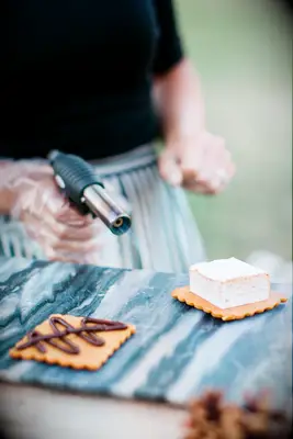Chef toasts a marshmallow to create a gourmet s