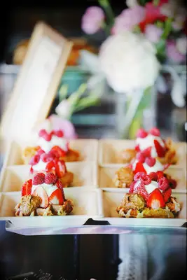 Belgian waffles served with a scoop of ice cream on top. 