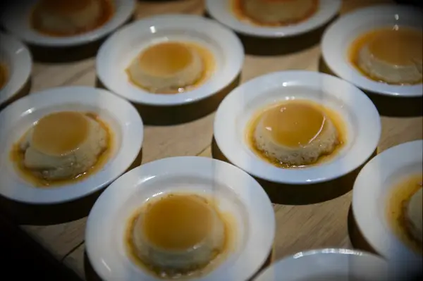 Plates of flan to be served at a wedding reception. 