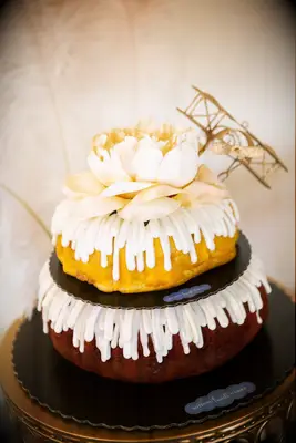 Tiered bundt cake with an elegant cake topper. 
