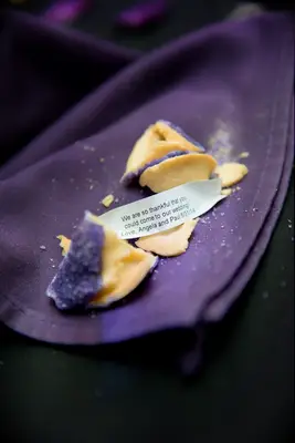 Fortune cookie dipped in chocolate and purple sprinkles. 