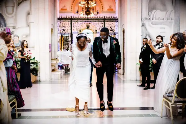 Couple jumping the broom at wedding
