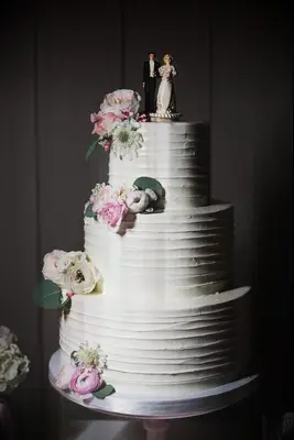 Elegant Three-Tier Wedding Cake With Vintage Topper