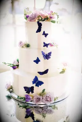 Purple Butterflies on three-tiered wedding Cake