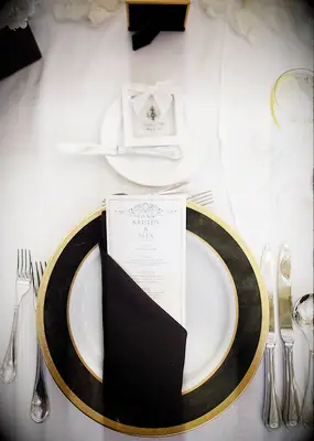 Black and white place setting at wedding