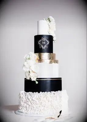 Black and white wedding cake with gold leaf