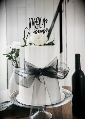 White wedding cake with black bow 