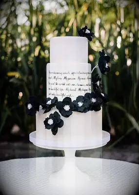 Black and white wedding cake with song lyrics