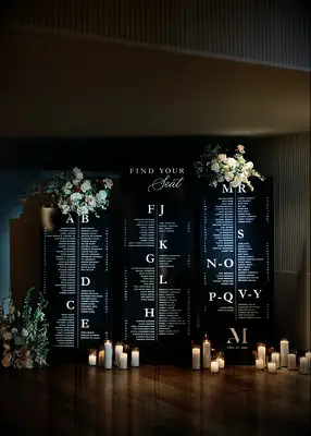 Candelit black and white seating chart at wedding