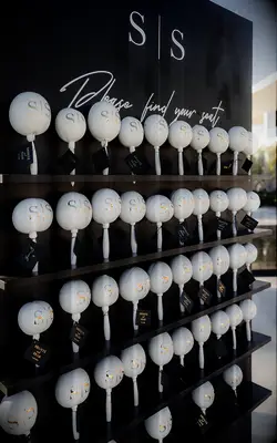 Black and white escort card display at wedding