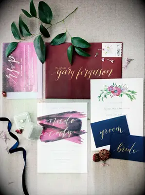 winter wedding invitation suite with burgundy and gold calligraphy envelope, dark purple watercolor details and navy blue place cards with gold calligraphy