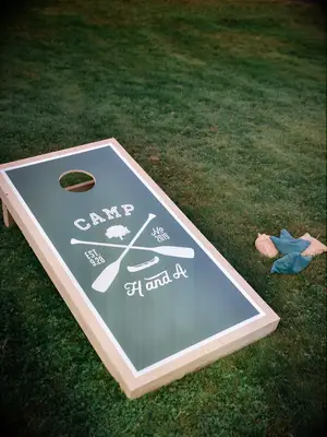 Custom cornhole boards at outdoor summer wedding