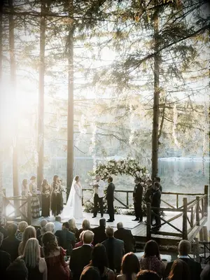 Elegant waterfront vow ceremony at outdoor summer wedding