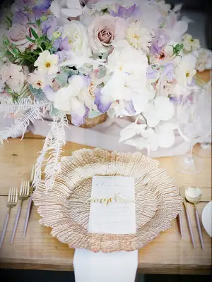 Pastel pink, purple and ivory flower centerpieces with rose gold accents at summer wedding