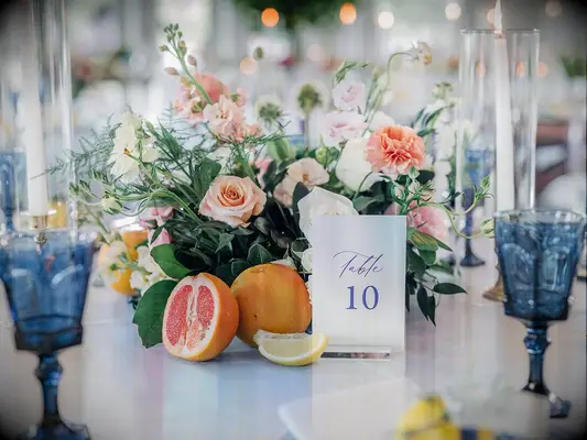 Floral and citrus centerpiece at summer wedding