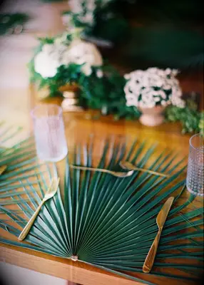 Palm frond charger at summer wedding