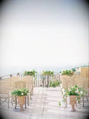 Minimal floral ceremony aisle decorations at outdoor summer wedding