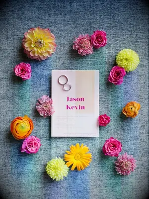 Pink wedding invitation with bright tropical pink and yellow flowers