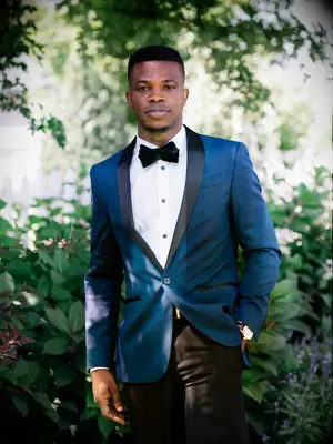 Groom wearing blue suit jacket for summer wedding ceremony