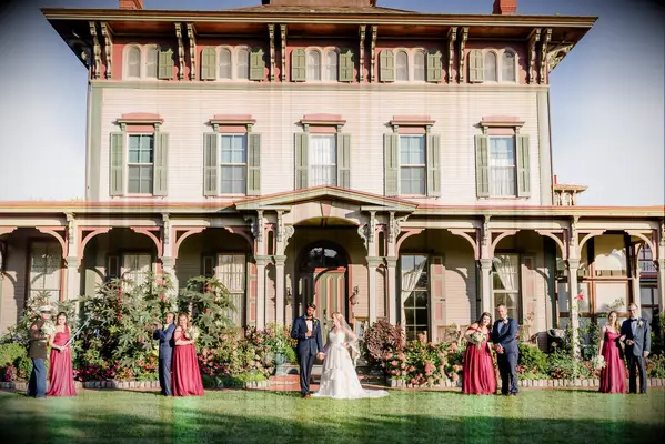 Couple and their wedding party posed outside the venue